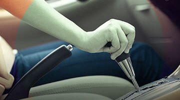 Close-up of a driver's hand on the gear selector